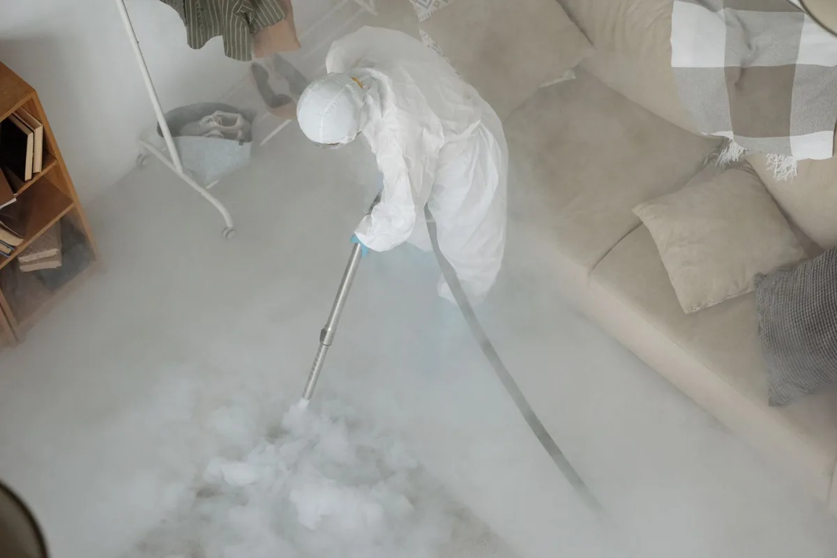 Biohazard cleanup technician in protective equipment, Fayette, MO